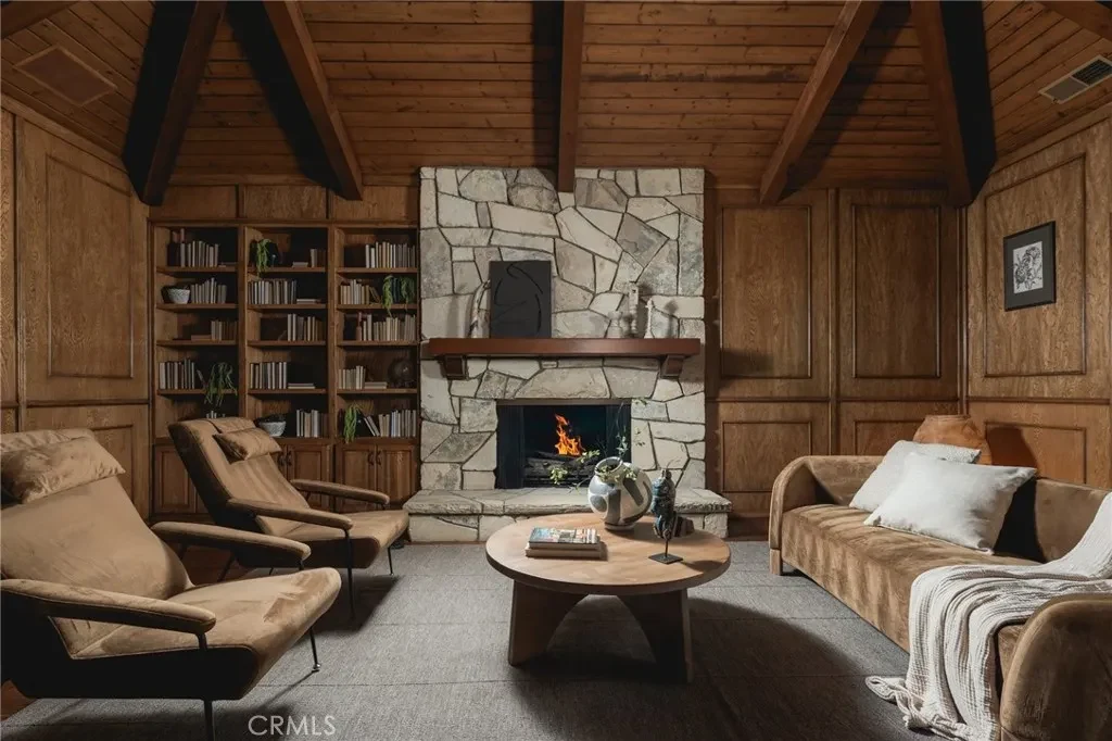 3201 Campanil Dr – Wood Paneled Study 3201 Campanil Dr, Santa Barbara: a wood-paneled study combines bookshelves with a stone fireplace.
