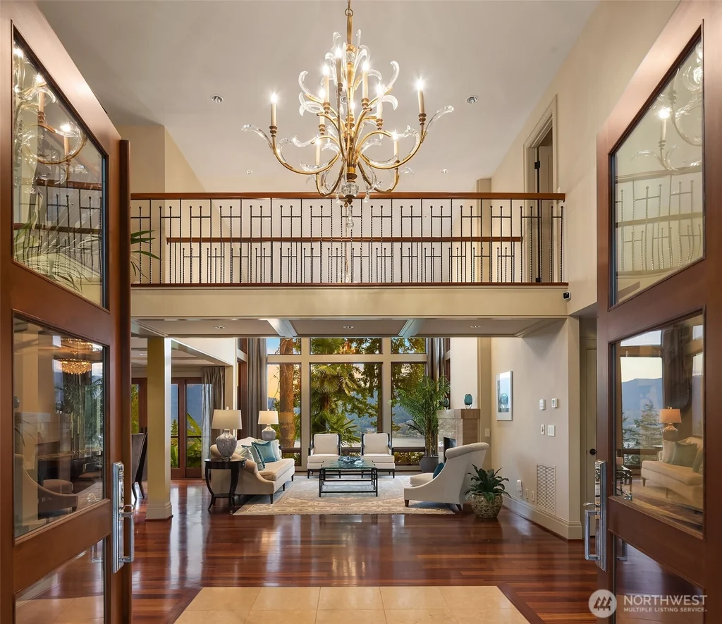 Pocket Doors Open to a Lake-View Pavilion at This Sammamish Estate Asking $6,880,000 3 Two-story foyer with an iron-railed bridge balcony and view toward the great room