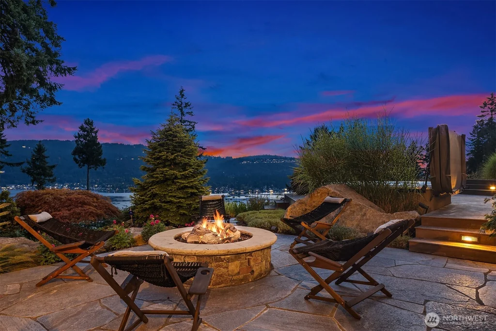 Pocket Doors Open to a Lake-View Pavilion at This Sammamish Estate Asking $6,880,000 19 Circular masonry fire pit and lounge chairs overlooking the lake