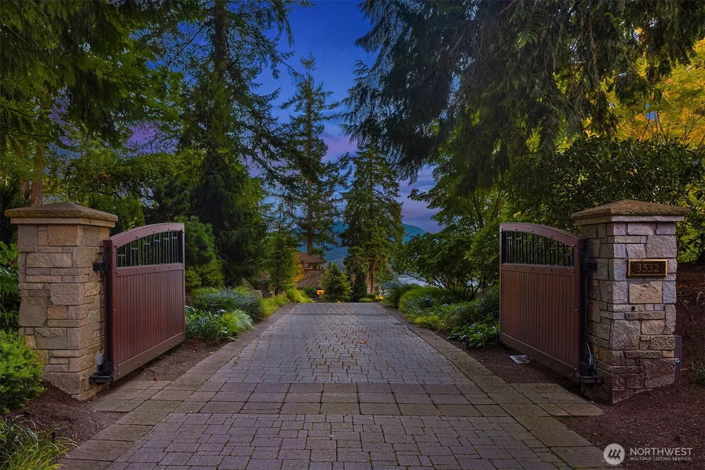 Pocket Doors Open to a Lake-View Pavilion at This Sammamish Estate Asking $6,880,000 2 Gated paved driveway with stone pillars at the Sammamish estate