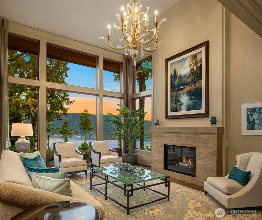 Pocket Doors Open to a Lake-View Pavilion at This Sammamish Estate Asking $6,880,000 4 Double-height great room with a fireplace and tall windows overlooking Lake Sammamish