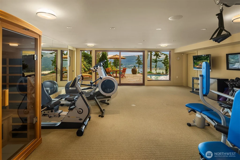 Pocket Doors Open to a Lake-View Pavilion at This Sammamish Estate Asking $6,880,000 17 Exercise room with fitness equipment and a glazed sauna enclosure