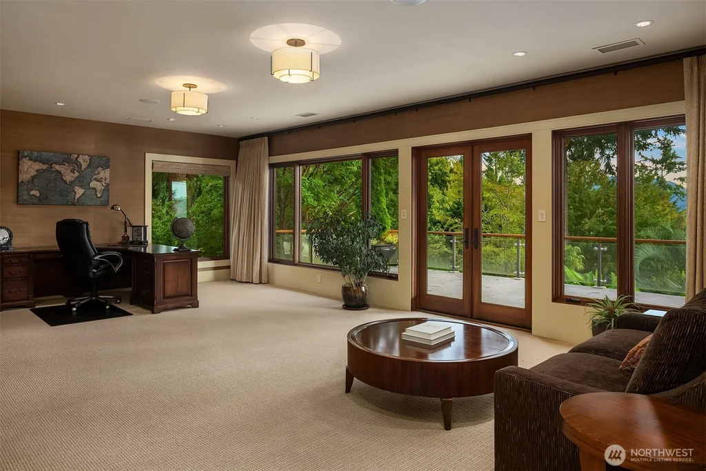 Pocket Doors Open to a Lake-View Pavilion at This Sammamish Estate Asking $6,880,000 14 Office and sitting area with glass doors opening to a deck