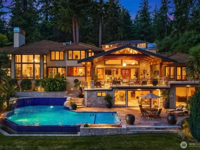 Pocket Doors Open to a Lake-View Pavilion at This Sammamish Estate Asking $6,880,000 3 Rear elevation and illuminated pool at 3532 207th Avenue SE in Sammamish