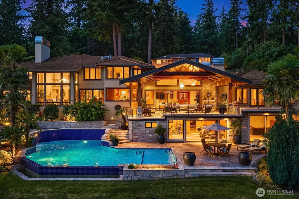 Pocket Doors Open to a Lake-View Pavilion at This Sammamish Estate Asking $6,880,000 1 Rear elevation and illuminated pool at 3532 207th Avenue SE in Sammamish