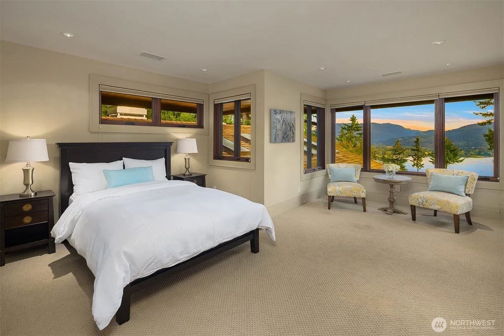 Pocket Doors Open to a Lake-View Pavilion at This Sammamish Estate Asking $6,880,000 15 Upper-level bedroom with a corner sitting area facing Lake Sammamish