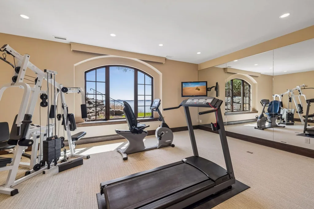 Wayzata Bay Estate With an Octagonal Great Room and 216 Feet of Shoreline Asks $16,450,000 17 The exercise room has windows overlooking the property at 358 Ferndale Rd S, Wayzata