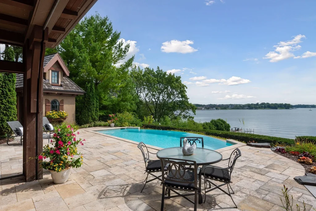 Wayzata Bay Estate With an Octagonal Great Room and 216 Feet of Shoreline Asks $16,450,000 18 A flagstone terrace places outdoor dining beside the pool and lake at 358 Ferndale Rd S, Wayzata