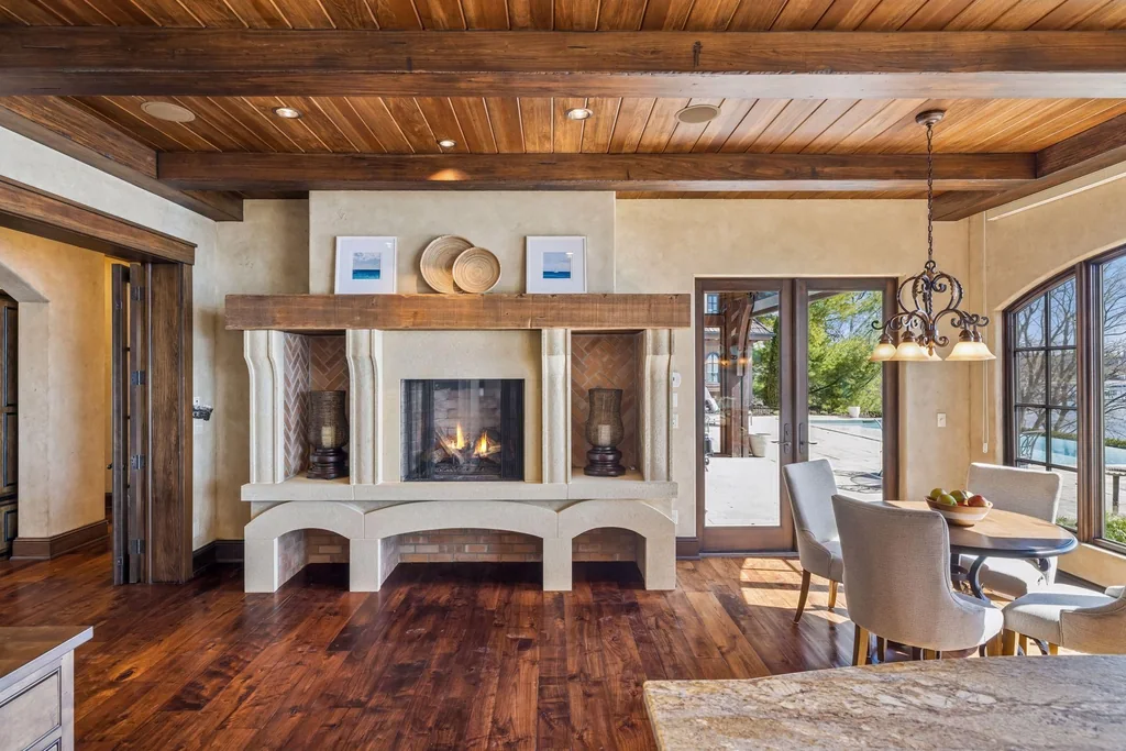 Wayzata Bay Estate With an Octagonal Great Room and 216 Feet of Shoreline Asks $16,450,000 9 A fireplace and built-in shelving form a gathering place beside the kitchen at 358 Ferndale Rd S, Wayzata