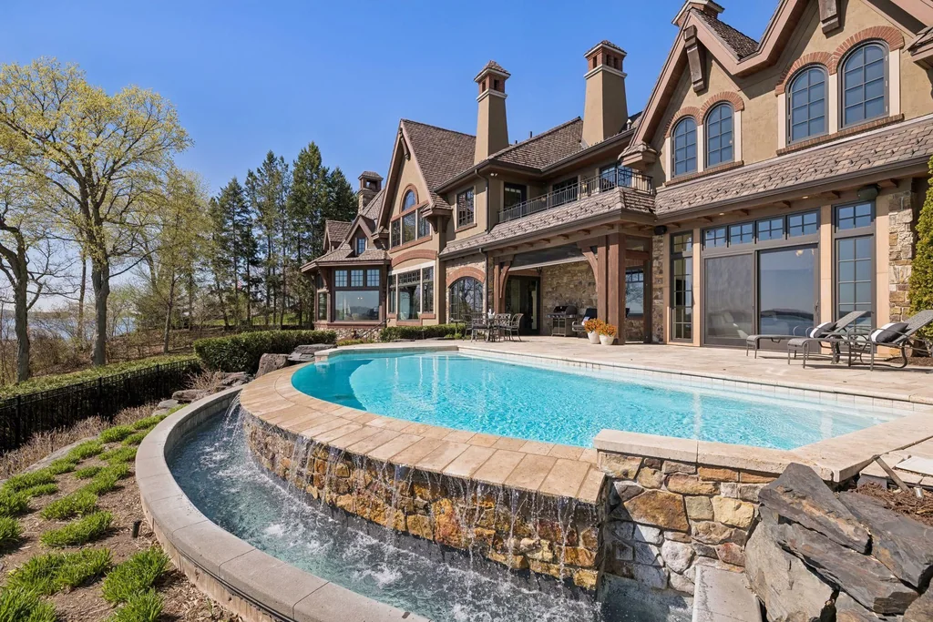 Wayzata Bay Estate With an Octagonal Great Room and 216 Feet of Shoreline Asks $16,450,000 19 A curved stone edge supports the pool above the lakeside gardens at 358 Ferndale Rd S, Wayzata