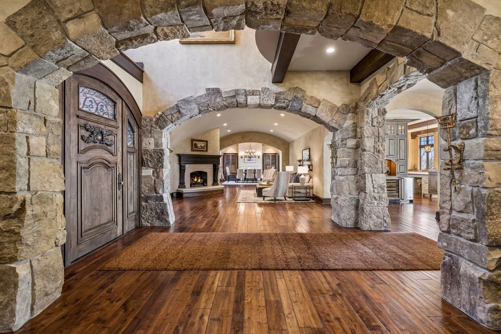 Wayzata Bay Estate With an Octagonal Great Room and 216 Feet of Shoreline Asks $16,450,000 4 Stone arches and a timber ceiling lead through the entrance hall at 358 Ferndale Rd S, Wayzata