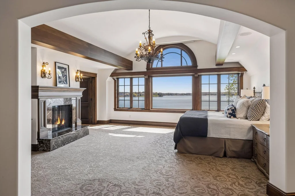 Wayzata Bay Estate With an Octagonal Great Room and 216 Feet of Shoreline Asks $16,450,000 14 The upper primary suite has a fireplace and an elevated view of the lake at 358 Ferndale Rd S, Wayzata