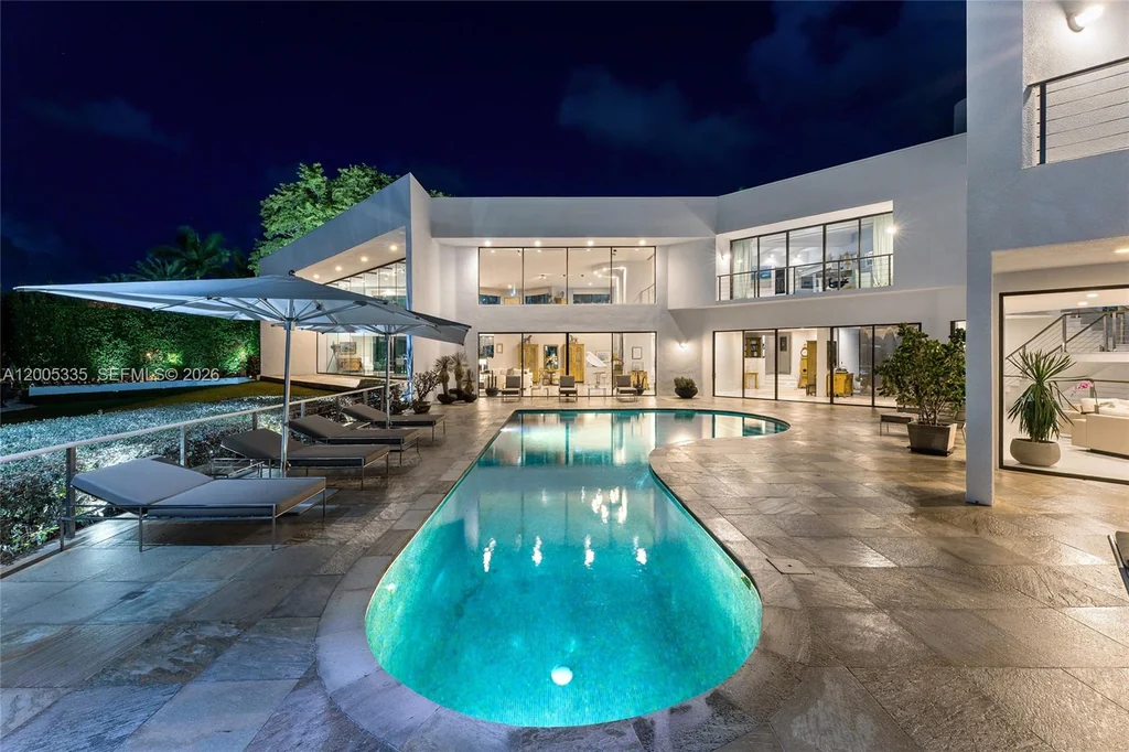485 W Matheson Dr – Piano Shaped Pool 485 W Matheson Dr, Key Biscayne: the piano-shaped pool glows against the white facade at twilight.
