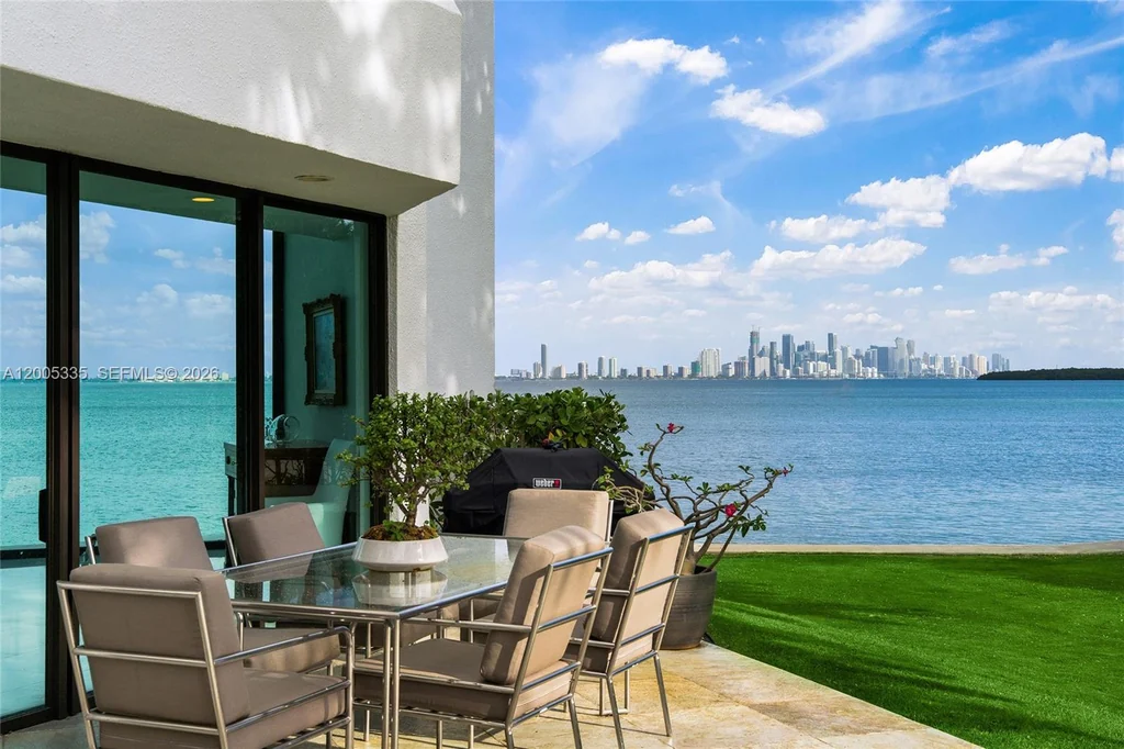 485 W Matheson Dr – Terrace Dining 485 W Matheson Dr, Key Biscayne: an outdoor dining terrace sits beside the waterfront lawn.