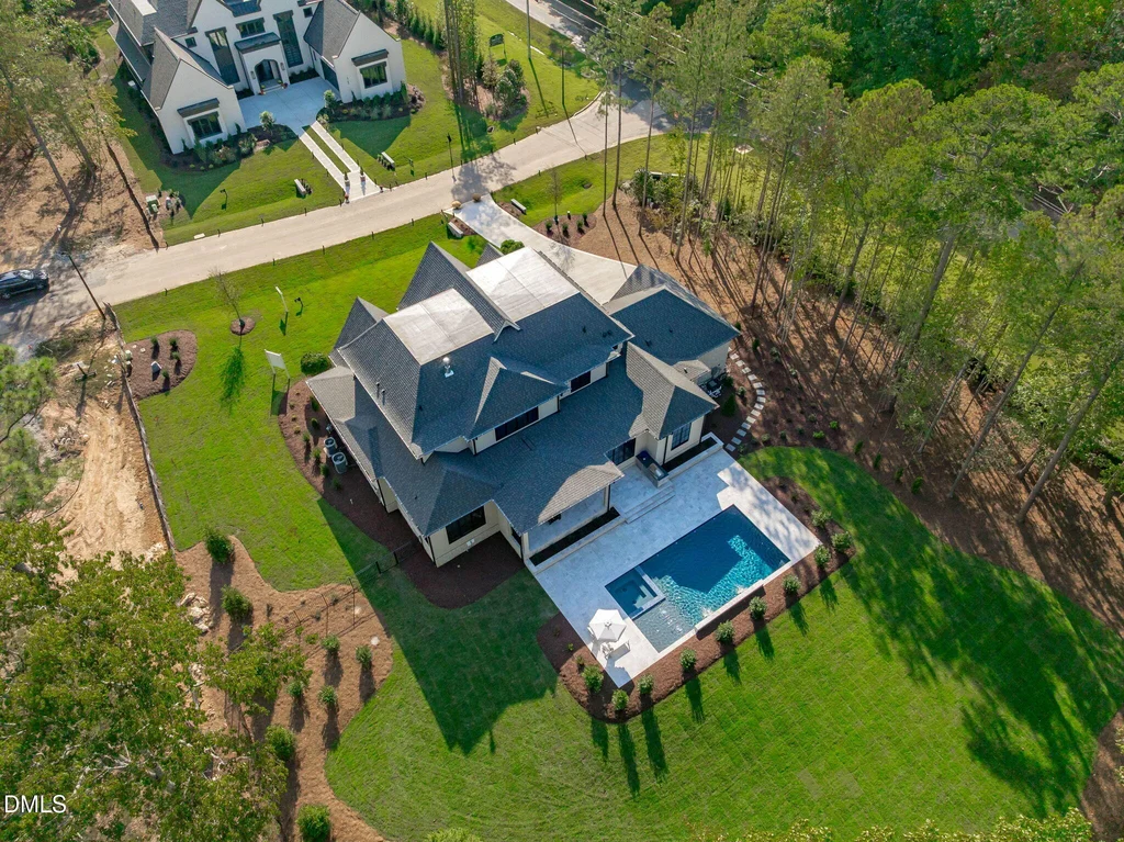 Aerial Pool Wooded Homesite | 6744 Brixley Crest Ct An aerial view shows the residence, pool and surrounding grounds at 6744 Brixley Crest Ct, Raleigh.