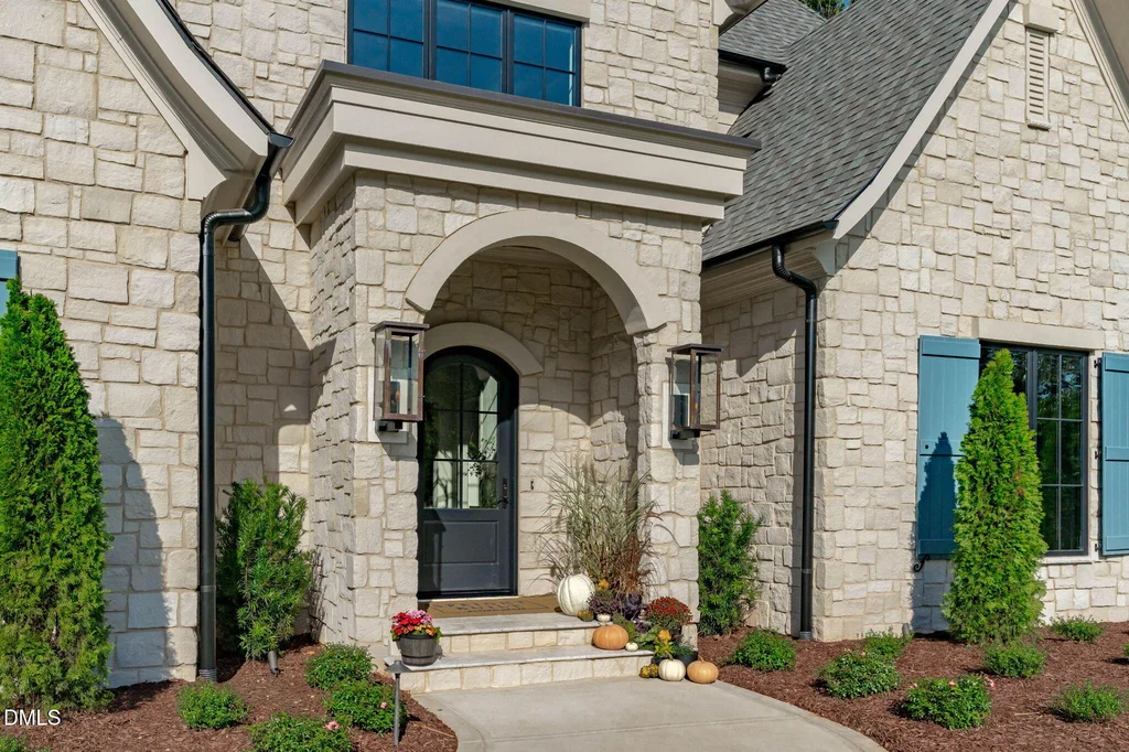 Arched Stone Entry | 6744 Brixley Crest Ct An arched entry establishes the home’s European-inspired architectural character at 6744 Brixley Crest Ct, Raleigh.