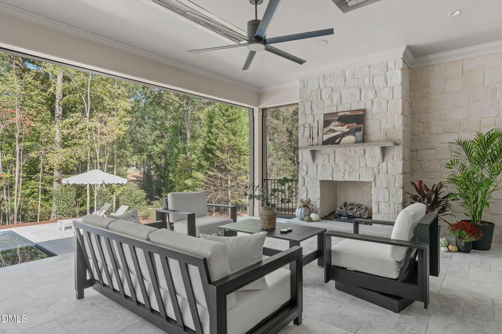 Covered Lounge Masonry Fireplace | 6744 Brixley Crest Ct The covered poolside lounge features an Isokern masonry fireplace at 6744 Brixley Crest Ct, Raleigh.