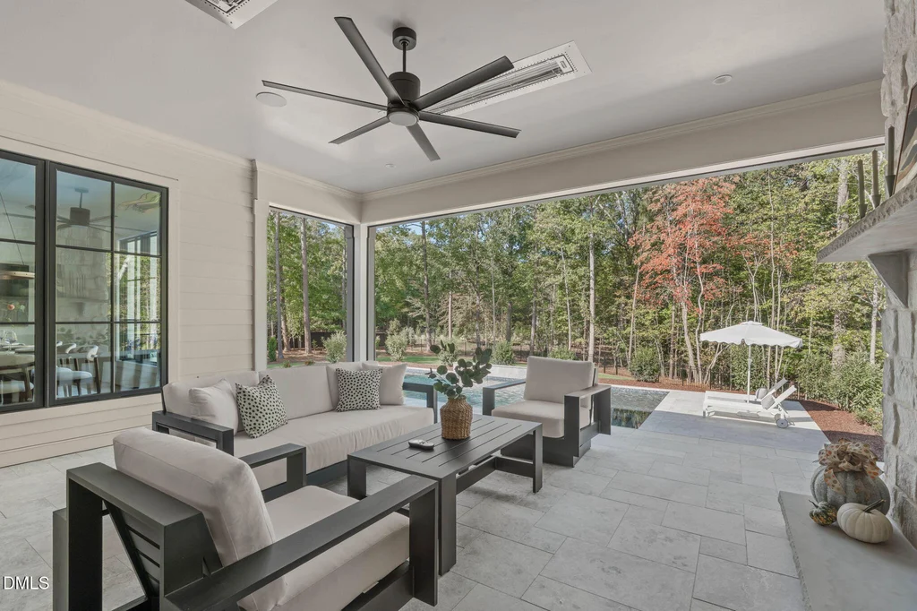 Covered Lounge Pool View | 6744 Brixley Crest Ct The sheltered outdoor living area opens toward the pool and spa at 6744 Brixley Crest Ct, Raleigh.