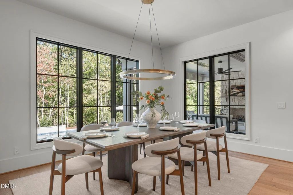Dining Room Wooded Outlook | 6744 Brixley Crest Ct Tall windows give the dining area an outlook toward the trees at 6744 Brixley Crest Ct, Raleigh.