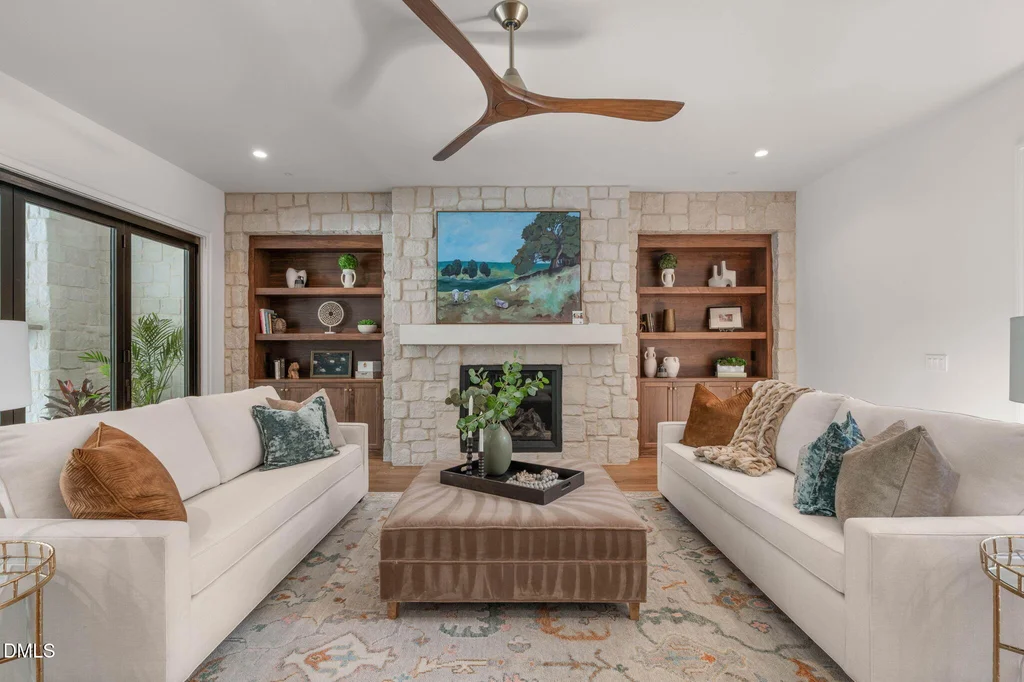 Living Room Stone Fireplace | 6744 Brixley Crest Ct A stone fireplace and built-in wood shelving anchor the living room at 6744 Brixley Crest Ct, Raleigh.