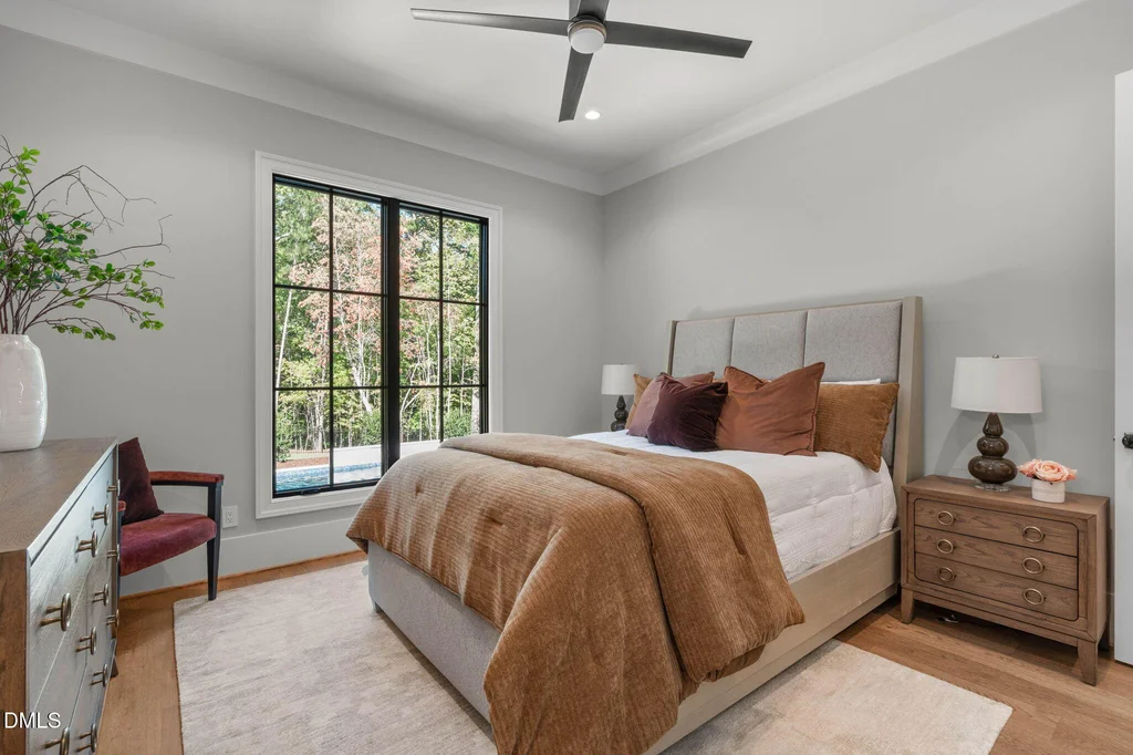Main Level Guest Bedroom | 6744 Brixley Crest Ct A separate guest suite provides additional main-level sleeping accommodations at 6744 Brixley Crest Ct, Raleigh.
