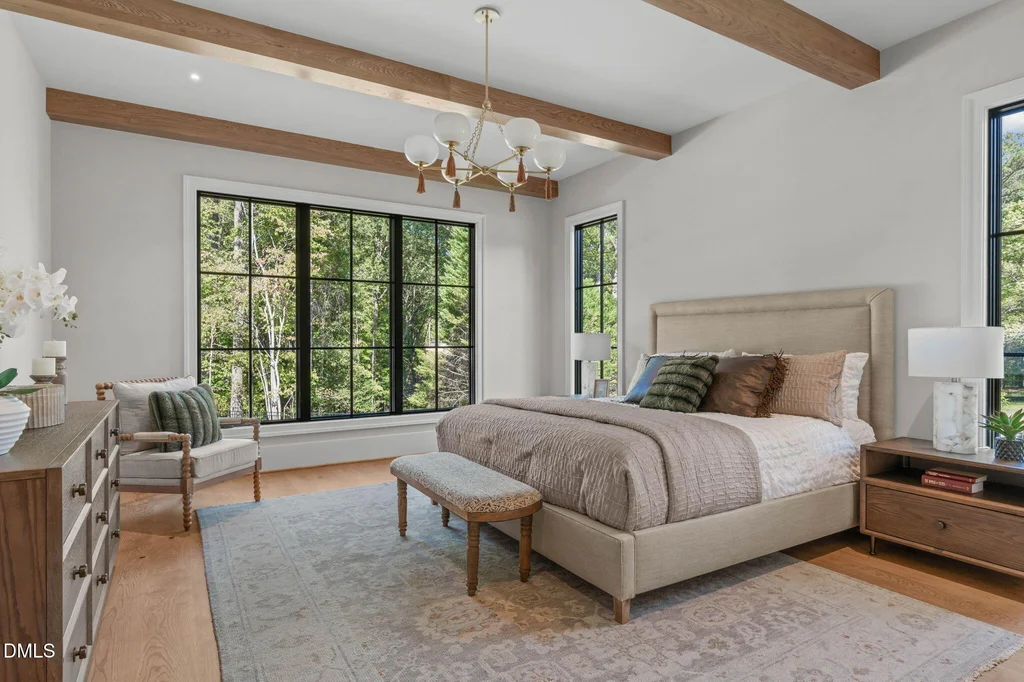 Main Level Primary Suite | 6744 Brixley Crest Ct Timber ceiling details bring warmth to the main-level primary suite at 6744 Brixley Crest Ct, Raleigh.