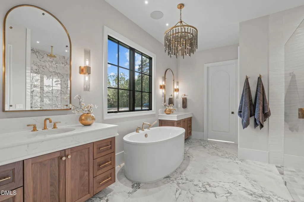 Primary Bath Freestanding Tub | 6744 Brixley Crest Ct The primary bathroom combines a freestanding tub with wood cabinetry at 6744 Brixley Crest Ct, Raleigh.