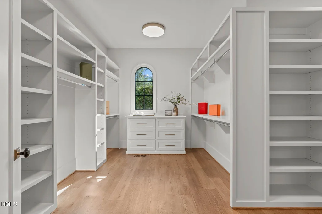 Primary Walk In Closet | 6744 Brixley Crest Ct The primary walk-in closet provides extensive built-in storage at 6744 Brixley Crest Ct, Raleigh.