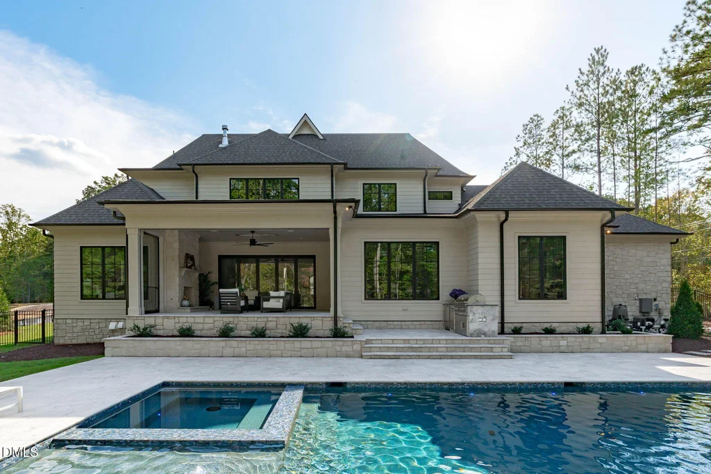 Saltwater Pool Spa Rear Elevation | 6744 Brixley Crest Ct The saltwater pool and spa frame the rear elevation of Stonewood Estate at 6744 Brixley Crest Ct, Raleigh.