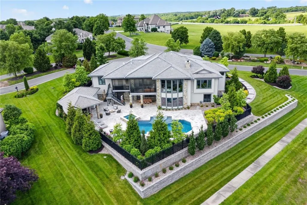 Striking Parkville Estate with a Floating Staircase and Fire-and-Water Pool Asks $3,550,000 30 8085 NW Green Glades Ct Parkville MO 6415221