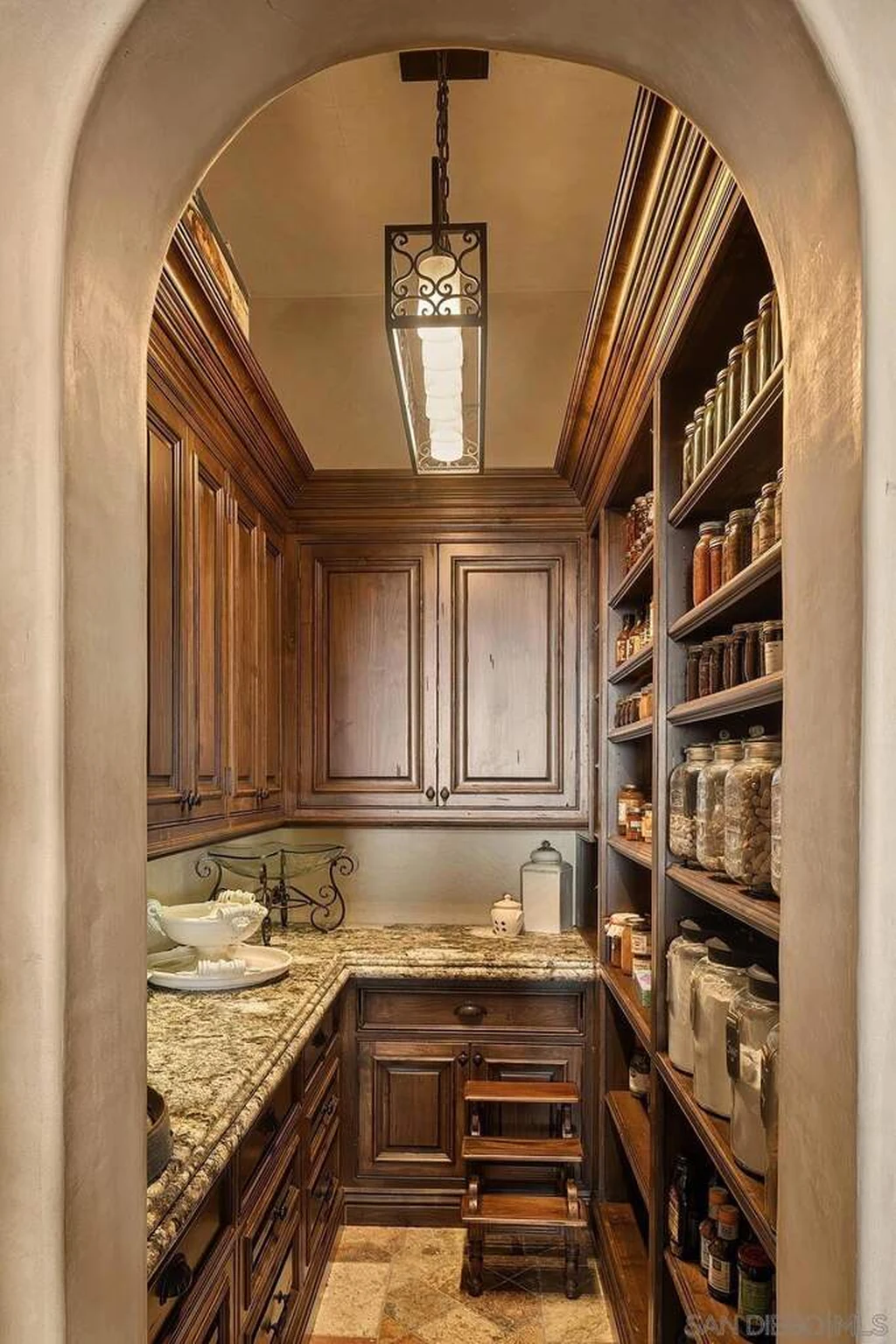 8619 Via Rancho Cielo – Butlers Pantry 8619 Via Rancho Cielo, Rancho Santa Fe: a narrow pantry is lined with fitted wood cabinetry and work surfaces.