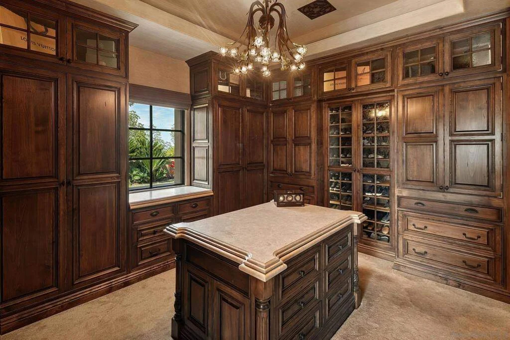 8619 Via Rancho Cielo – Dressing Room 8619 Via Rancho Cielo, Rancho Santa Fe: extensive wood cabinetry surrounds a central island in the dressing room.