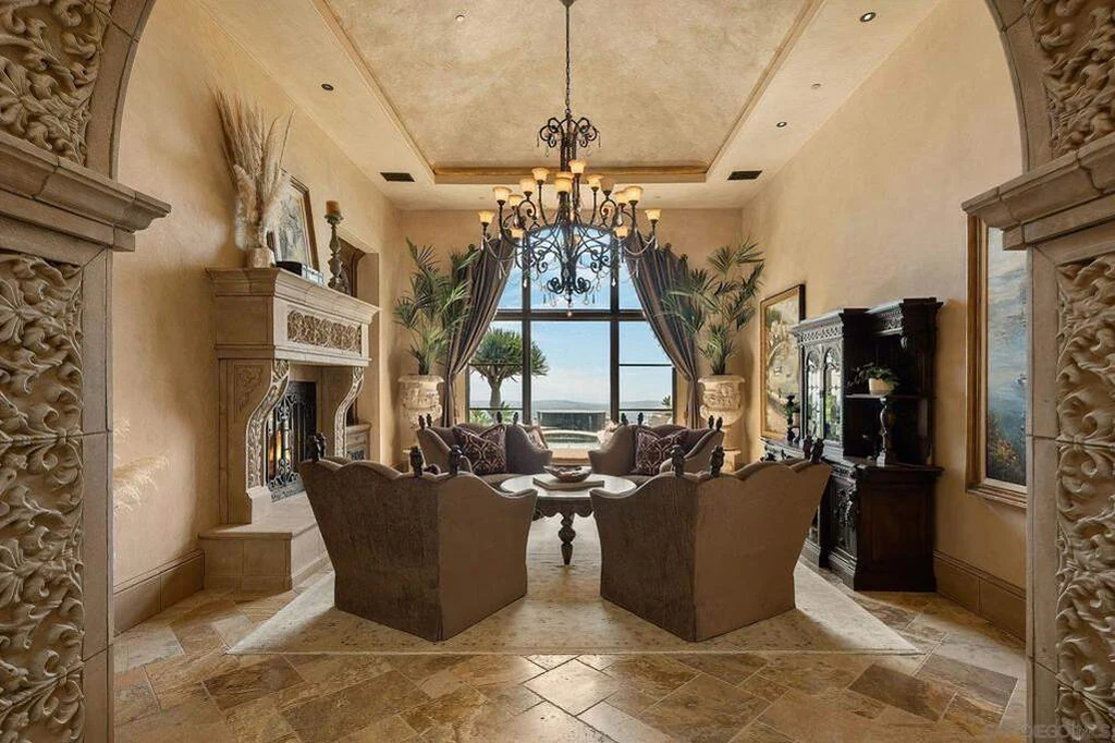 8619 Via Rancho Cielo – Formal Living Room 8619 Via Rancho Cielo, Rancho Santa Fe: a tall arched window frames the view from the formal living room.