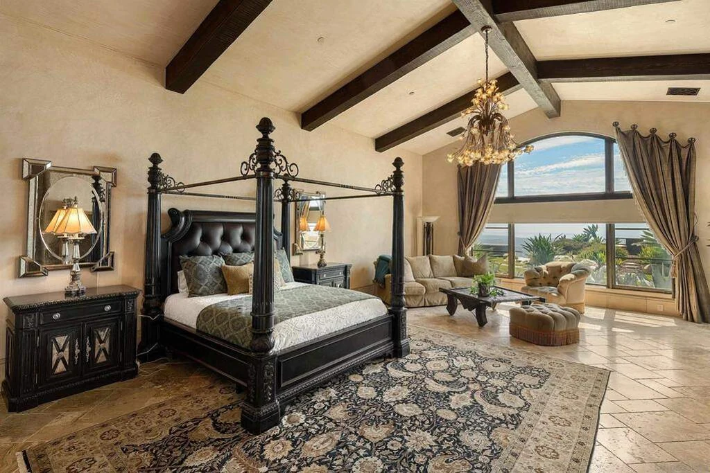 8619 Via Rancho Cielo – Primary Bedroom 8619 Via Rancho Cielo, Rancho Santa Fe: the primary bedroom pairs a timber ceiling with broad arched glazing.