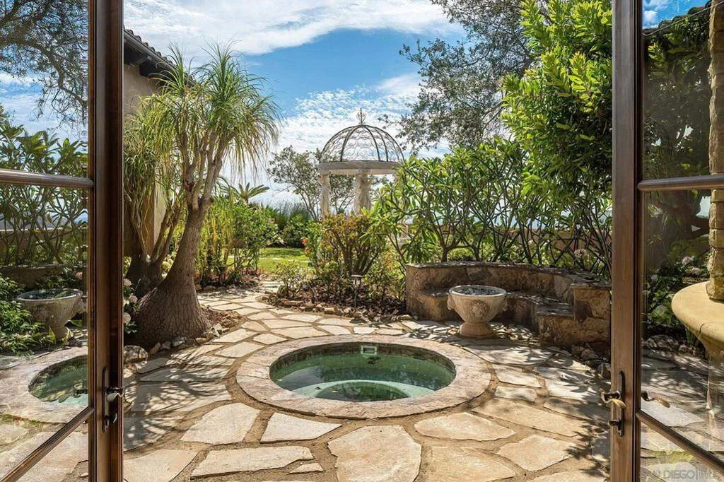 8619 Via Rancho Cielo – Private Spa Courtyard 8619 Via Rancho Cielo, Rancho Santa Fe: a sheltered courtyard contains a circular spa beside mature planting.