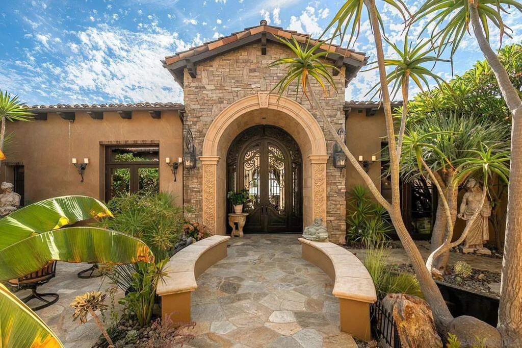 8619 Via Rancho Cielo – Stone Entry 8619 Via Rancho Cielo, Rancho Santa Fe: a stone entry tower and arched doorway introduce the home.